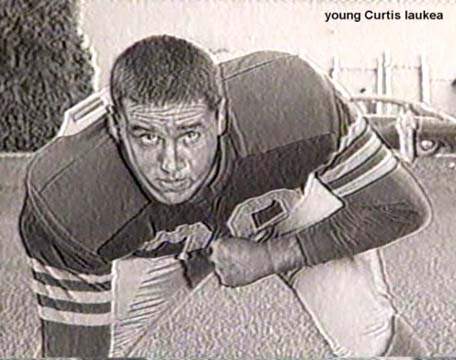 Younger Iaukea in football gear